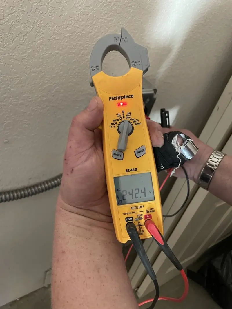 Voltage testing with clamp meter during Electrical Installation Services in Alma
